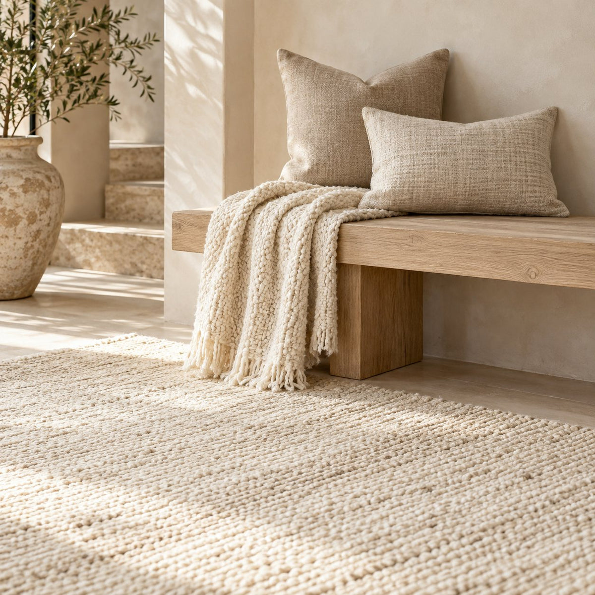 Rugs & Textiles collection: a textured cream rug, linen cushions and a soft knitted throw