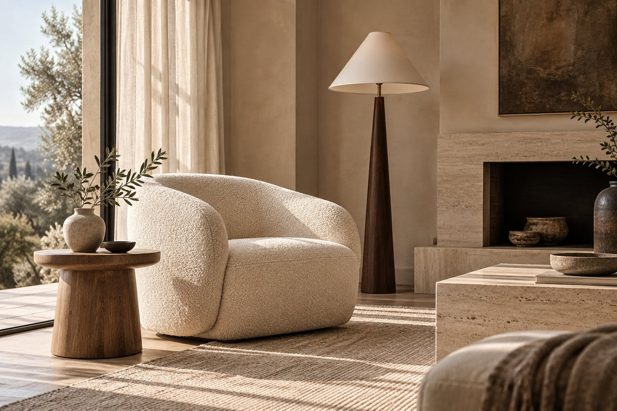 Warm neutral living room with a cream lounge chair, oak side table and soft afternoon light — interior inspiration